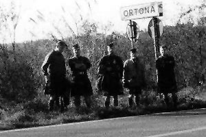 Canadian Highlanders pose by a Ortona road sign.