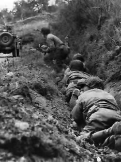 US Riflemen use a ditch for cover