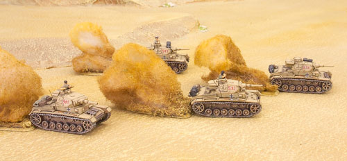 Panzer III tanks race across the desert